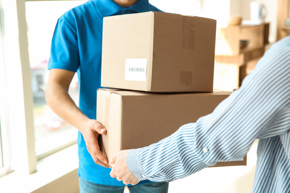 Woman Receiving Boxes from Delivery Man